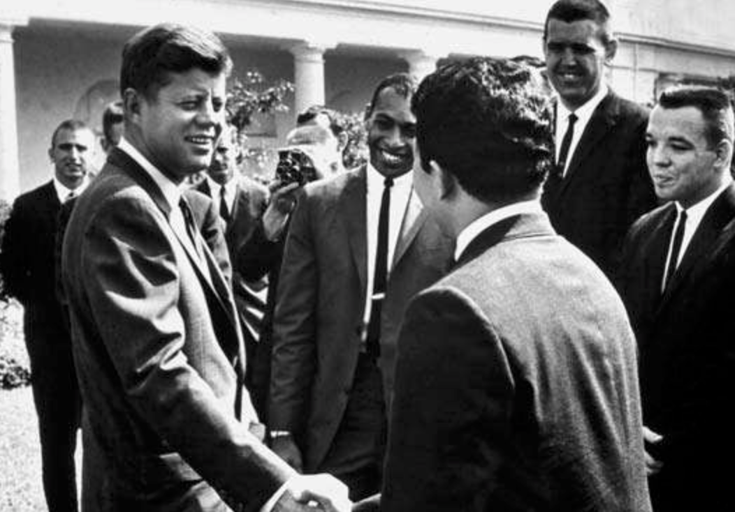 Vintage photograph of President John F Kennedy shaking hands with a group of men